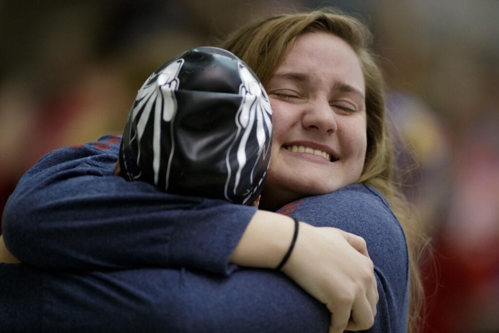 Ƶ's Lindsay Dowling a junior from Winston, Ga. hugs Ƶ's Ella Kleinschmidt a senior from Hervey Bay, Queensland Australia after the 400-yard freestyle relay during the finals of the NAIA Swimming & Diving National Championship on Saturday, March 3, 2018, in Columbus, Ga. (AJ Reynolds/Ƶ)